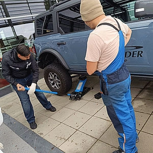 Schüler beim Reifenwechsel